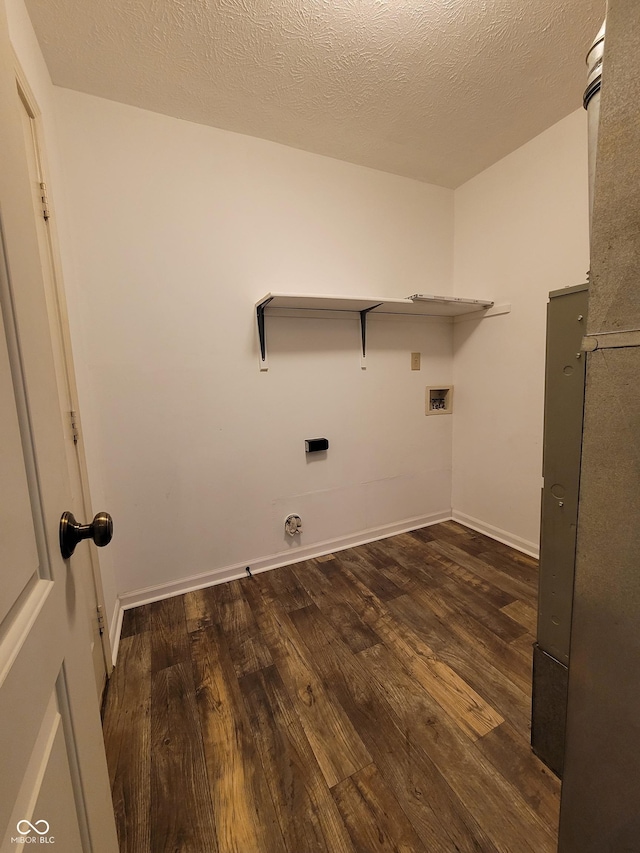 laundry room featuring dark wood-type flooring, a textured ceiling, and washer hookup