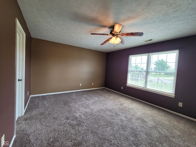 unfurnished room featuring ceiling fan, carpet floors, and a textured ceiling