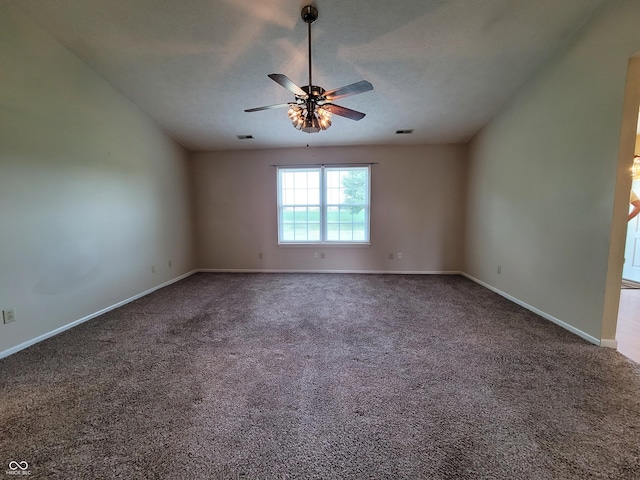 unfurnished room featuring ceiling fan, dark carpet, and a textured ceiling