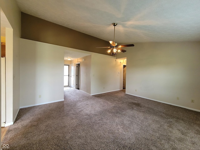 empty room featuring carpet, ceiling fan, lofted ceiling, and a textured ceiling