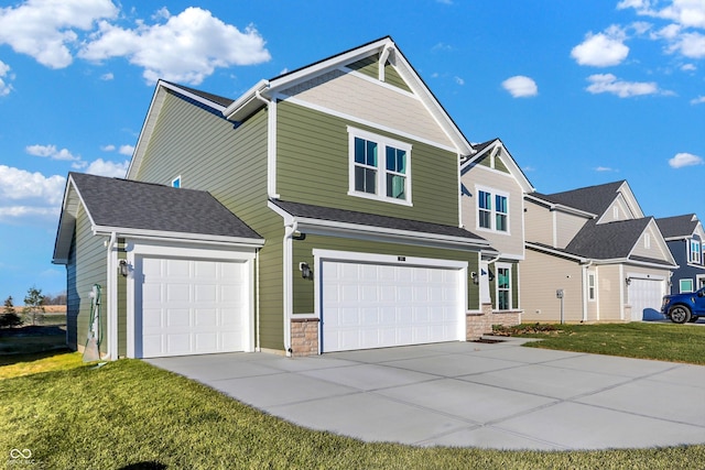 view of front of property featuring a front yard and a garage