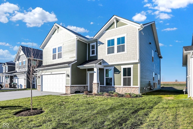 view of front of property featuring a garage and a front lawn