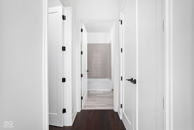 corridor featuring dark hardwood / wood-style floors