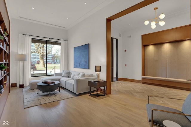 living room with light hardwood / wood-style flooring and a notable chandelier