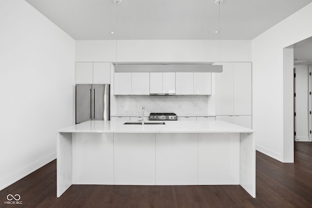 kitchen with white cabinetry, sink, stainless steel appliances, dark hardwood / wood-style floors, and an island with sink