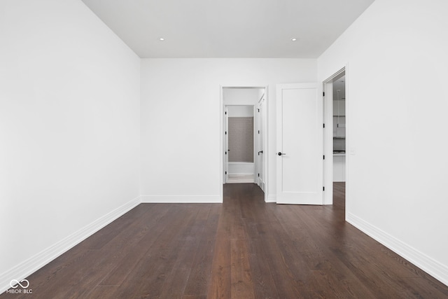 spare room featuring dark hardwood / wood-style flooring