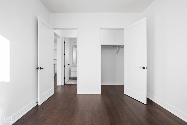 unfurnished bedroom featuring dark hardwood / wood-style floors and a closet