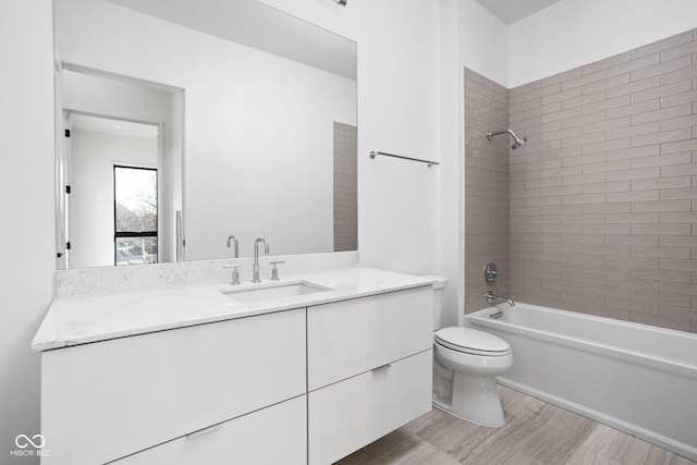 full bathroom with vanity, toilet, and tiled shower / bath