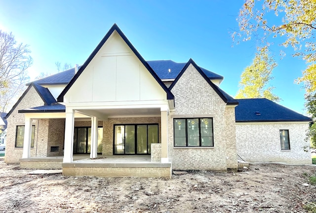 rear view of property featuring a patio area