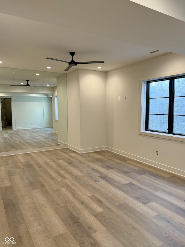 unfurnished bedroom featuring ceiling fan, a closet, and light hardwood / wood-style flooring