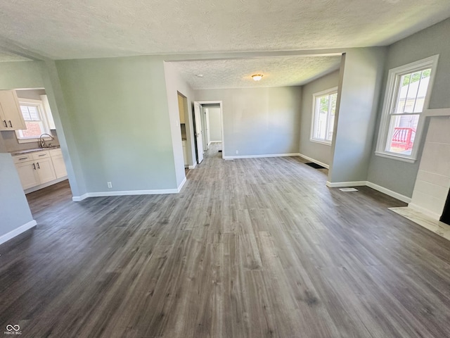 interior space with wood-type flooring and a textured ceiling