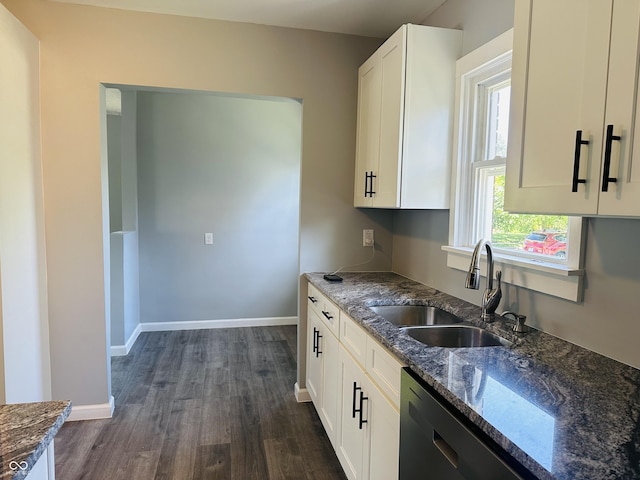 kitchen with dark stone counters, sink, stainless steel dishwasher, dark hardwood / wood-style flooring, and white cabinetry