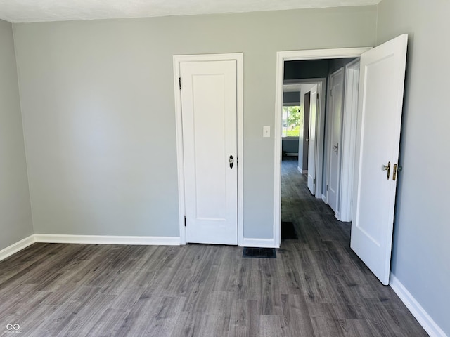 unfurnished bedroom featuring dark hardwood / wood-style floors