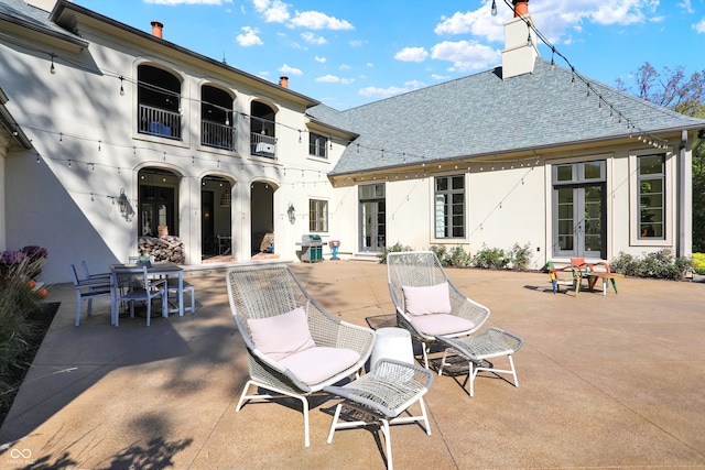 view of patio with a grill and a balcony