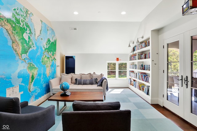 living room featuring a wealth of natural light, french doors, and dark hardwood / wood-style floors