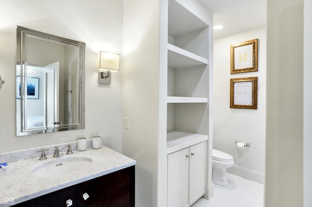 bathroom featuring vanity, toilet, and tile patterned floors