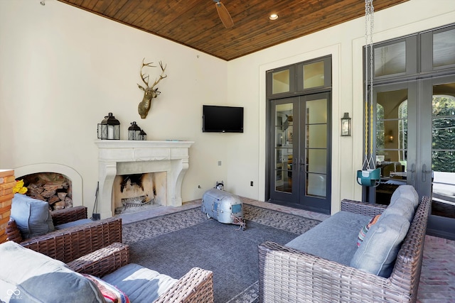 view of patio featuring french doors and exterior fireplace