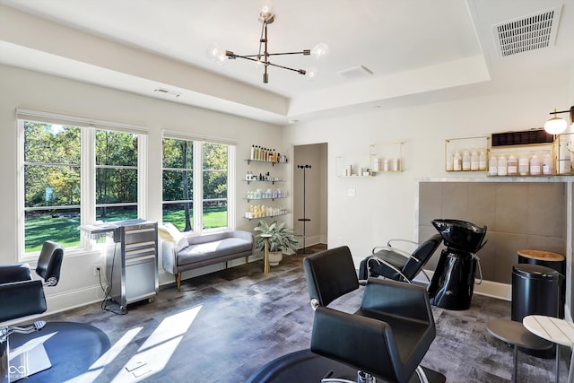 interior space featuring a tray ceiling, a chandelier, dark hardwood / wood-style flooring, and a healthy amount of sunlight