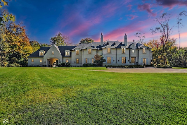 french country home with a lawn