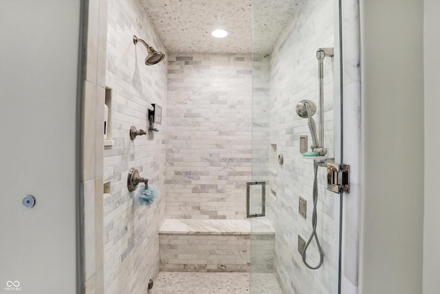 bathroom featuring a shower with shower door