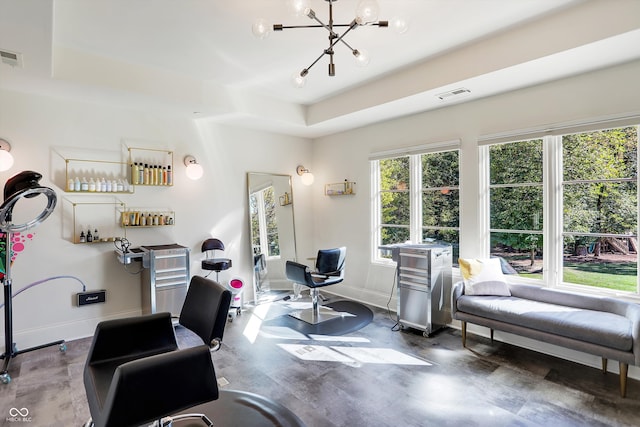 office with an inviting chandelier and a raised ceiling