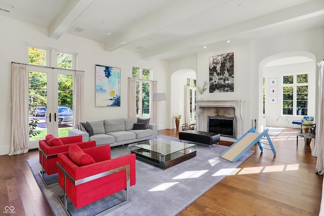 living room featuring beam ceiling and hardwood / wood-style flooring