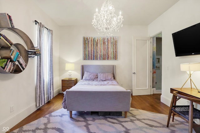 bedroom featuring wood-type flooring and a notable chandelier