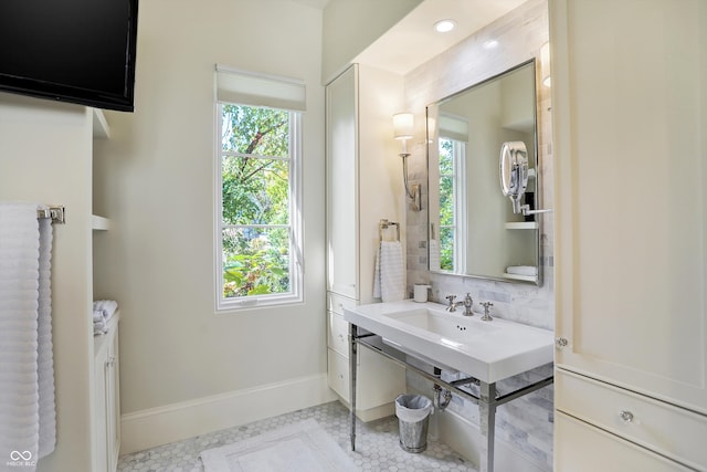 bathroom featuring tasteful backsplash, plenty of natural light, and tile patterned floors