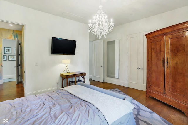 bedroom with an inviting chandelier and dark hardwood / wood-style flooring