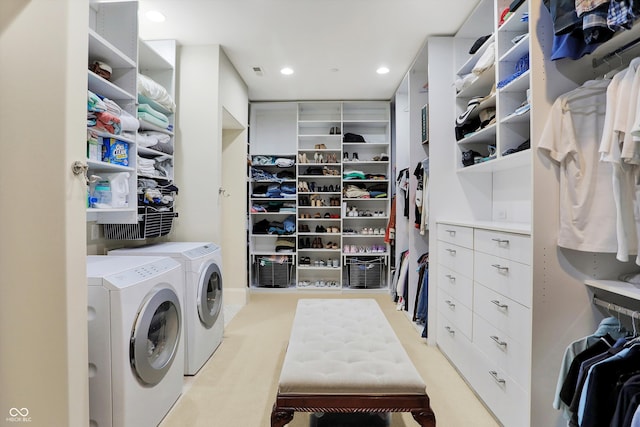 interior space featuring washing machine and dryer and light carpet