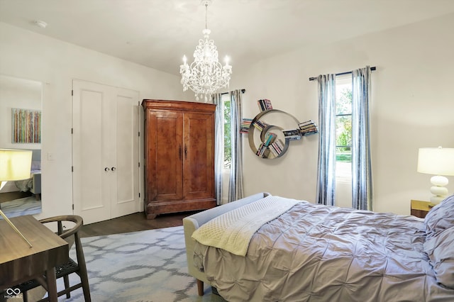 bedroom with a chandelier and dark hardwood / wood-style flooring