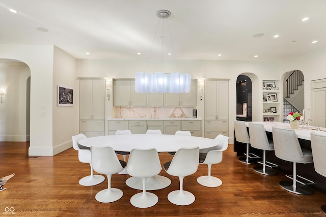 dining room with hardwood / wood-style flooring and built in features