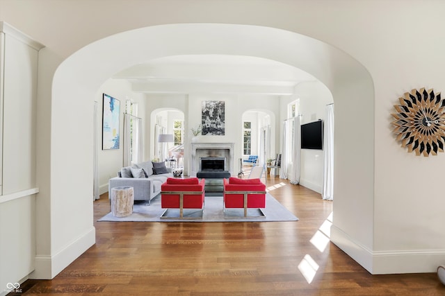 living room with beam ceiling and hardwood / wood-style floors