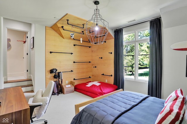 bedroom featuring wood walls and carpet