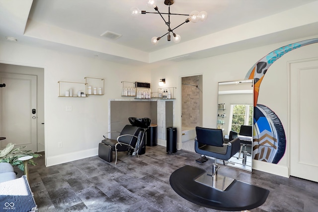 living area featuring a raised ceiling and an inviting chandelier