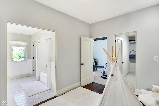 interior space featuring hardwood / wood-style floors and shower with separate bathtub