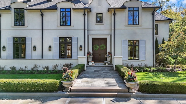 french country style house with a front lawn