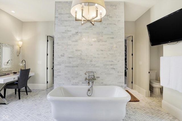 bathroom with tile patterned flooring, a washtub, an inviting chandelier, and toilet