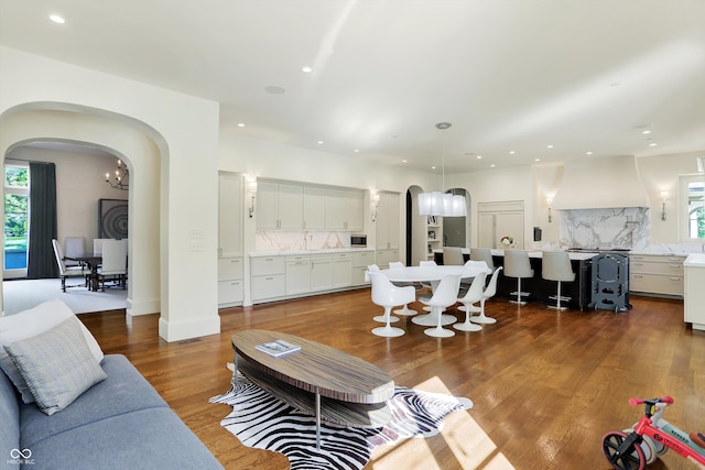 living room featuring dark hardwood / wood-style flooring and sink