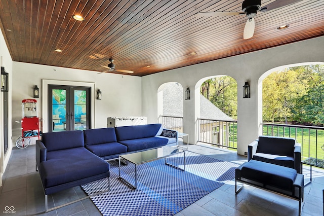 view of patio featuring french doors, an outdoor living space, and ceiling fan