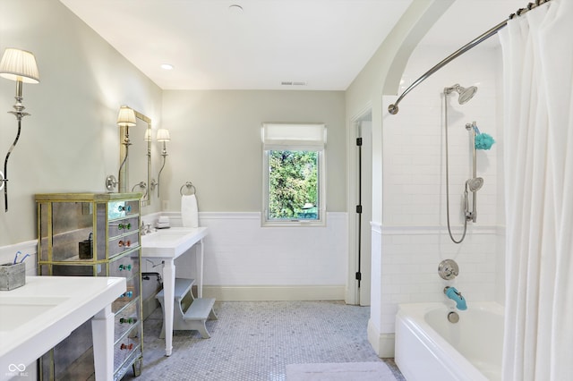 bathroom featuring shower / tub combo with curtain, tile patterned floors, and vanity