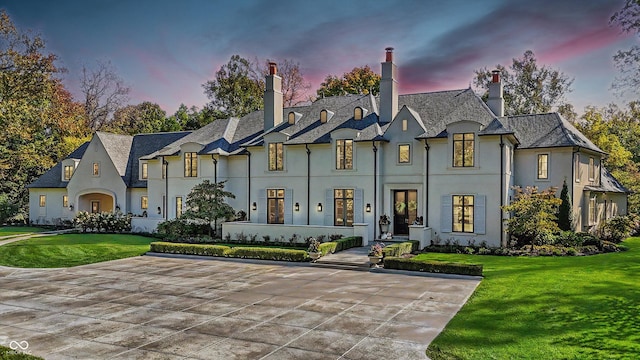 french country style house with a lawn