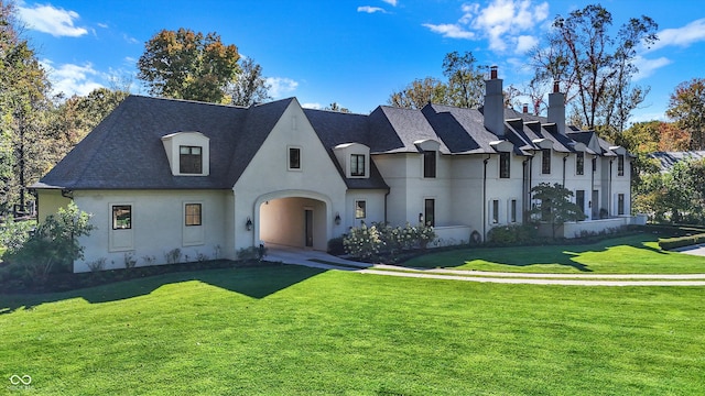 french country inspired facade featuring a front lawn