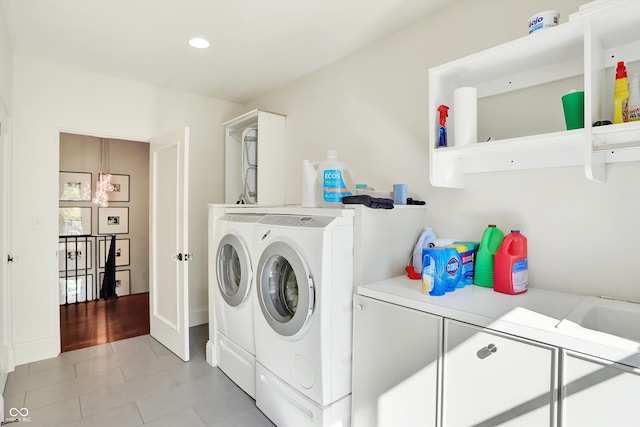 laundry room featuring separate washer and dryer and light tile patterned floors