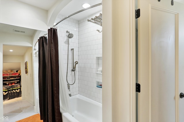 bathroom featuring shower / bath combination with curtain and tile patterned floors