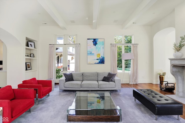 living room featuring french doors, hardwood / wood-style floors, beam ceiling, and built in shelves