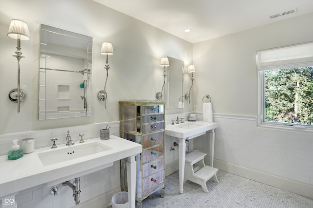 bathroom with tile walls and tile patterned flooring