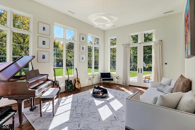 sunroom / solarium featuring french doors