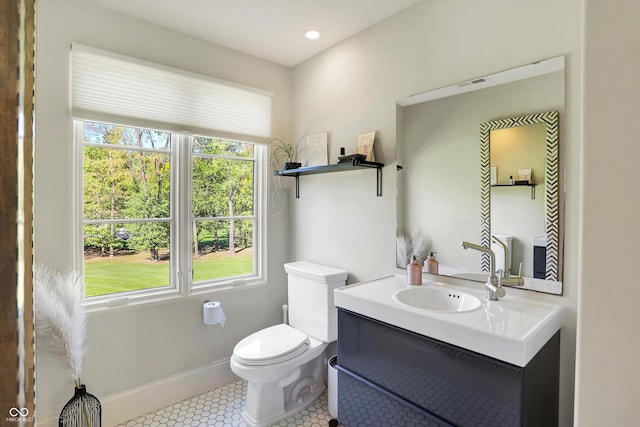 bathroom featuring tile patterned flooring, vanity, and toilet