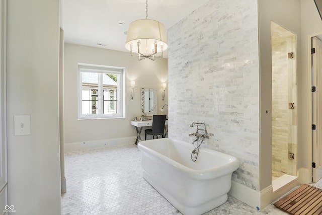 bathroom with a notable chandelier, tile patterned flooring, and plus walk in shower